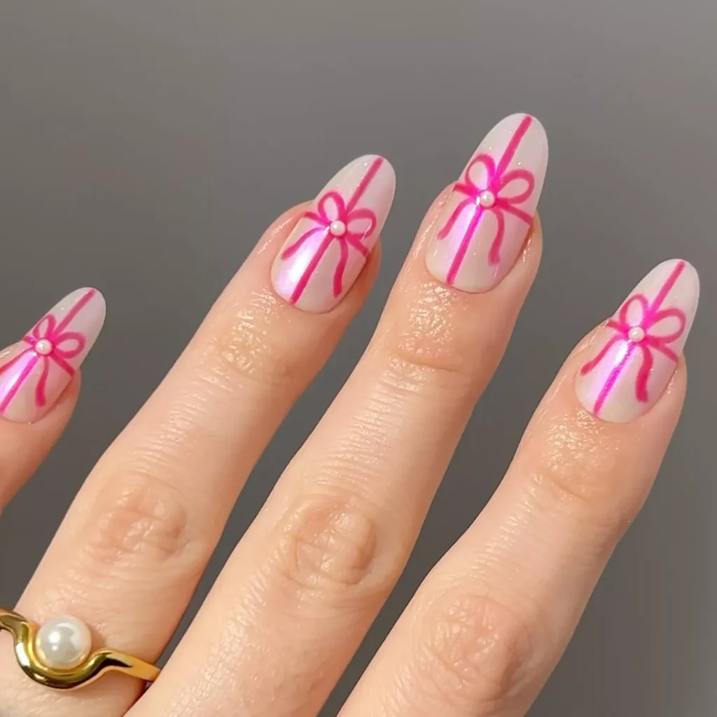 Soft pink manicure with bright pink bow nail art by pop_polished