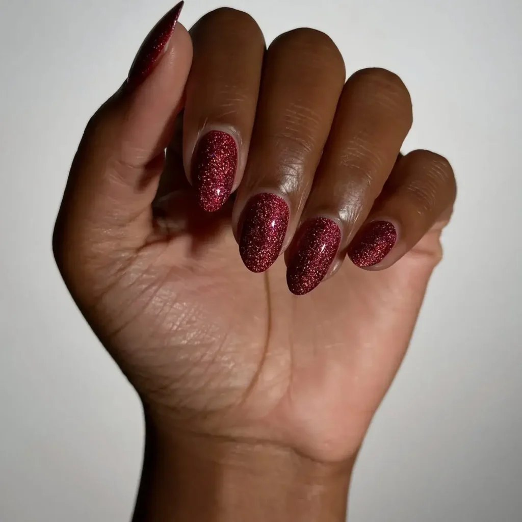 Sparkly ruby red almond-shaped nails. by melanated.mani
