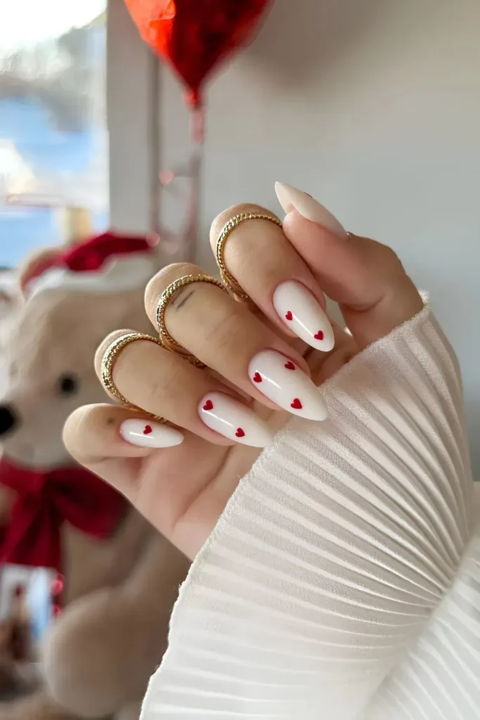 White manicure with simple, hand-painted red hearts. by monail_s

