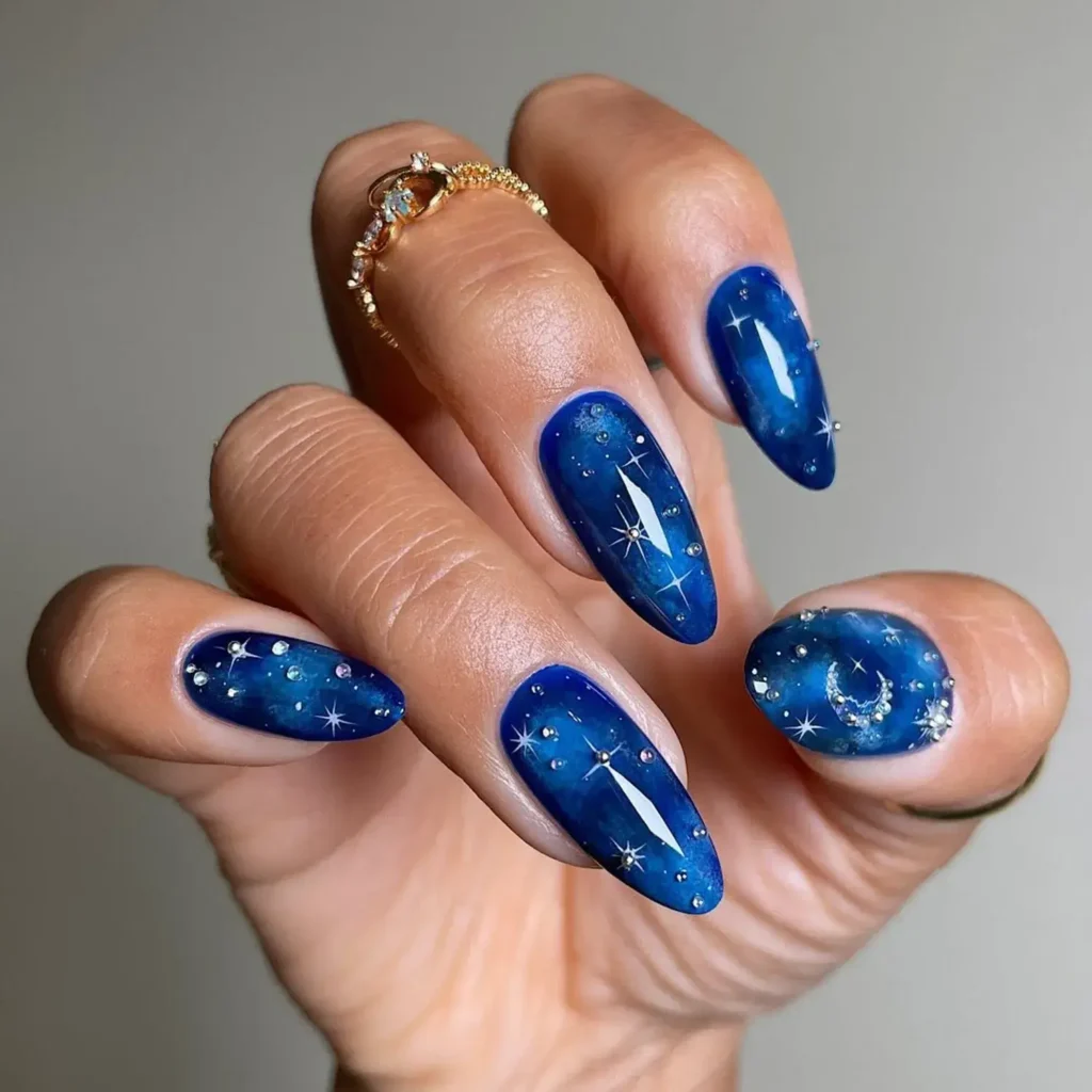 Deep blue cosmic base with tiny star sparkles. by sansungnails