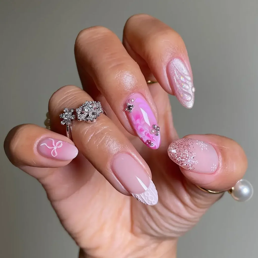 Pink wintry designs with snowflake and bow accents. by sansungnails